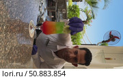 Sh arm eli Sheikh Egypt June 12 2025.A male bartender carefully prepares a vibrant layered cocktail, garnished with colorful fruits. The drink shimmers with a spectrum of colors, creating a visually. Редакционное видео, видеограф Zita Khasanova / Фотобанк Лори