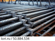 Reinforcing steel bars connected with metal clamps forming grid structure. Стоковое AI-изображение, AI-художник Иван Рябоконь / Фотобанк Лори