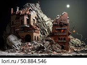 Miniature city crumbling under full moon with rescuers searching for survivors. Стоковое AI-изображение, AI-художник Иван Рябоконь / Фотобанк Лори