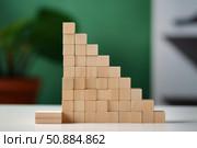 Wooden cubes forming descending steps on reflective surface. Стоковое AI-изображение, AI-художник Иван Рябоконь / Фотобанк Лори