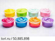 Colorful slimes in plastic containers creating a vibrant and playful scene. Стоковое AI-изображение, AI-художник Иван Рябоконь / Фотобанк Лори
