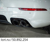 Novosibirsk, Russia -  July 14, 2025: Porsche Cayenne,  Close-up of dual chrome exhaust pipes. Редакционное фото, фотограф Виталий Сова / Фотобанк Лори