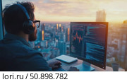 A dedicated professional immersed in data analytics on a monitor, overlooking a sprawling city at golden hour. Стоковое AI-видео, аниматор Данила Большаков / Фотобанк Лори
