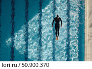 Diver in sleek black suit gracefully plunges into clear blue water creating ripples and splashes. Стоковое AI-изображение, AI-художник Гайфуллина Дина / Фотобанк Лори