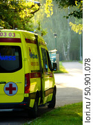 A yellow ambulance is on duty in the park. Редакционное фото, фотограф Ярославский Максим / Фотобанк Лори