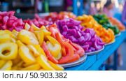 Colorful display of pickled vegetables on a blue table. Стоковое AI-изображение, AI-художник Данила Большаков / Фотобанк Лори