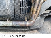 Exhaust system with lambda sensor and carbon fiber body in a sports car. Стоковое фото, фотограф Андрей Знаменский / Фотобанк Лори