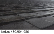 Close-up of asphalt shingle roof during heavy rain. raindrops hit the surface intensely, creating visible splashes and fast-moving water streams. dynamic weather scene. Стоковое видео, видеограф Анастасия Ли / Фотобанк Лори