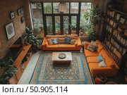 A cozy living room in an eclectic style with elements of boho and rustic. The center of the composition are two bright orange sofas, lots of patterned pillows, a vintage wooden table and an oriental rug in blue and orange tones. The room is filled with plants, bookshelves and natural light coming through the panoramic windows. The interior radiates warmth, comfort and individuality. Ideal for interior design themes, coziness, modern housing and home privacy. Стоковое AI-изображение, AI-художник Анна Кривицкая / Фотобанк Лори