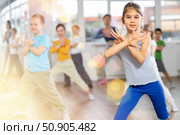 Children studying modern style dances with female teacher in dance class. Стоковое фото, фотограф Яков Филимонов / Фотобанк Лори