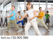 Children studying modern style dances with female teacher in dance class. Стоковое фото, фотограф Яков Филимонов / Фотобанк Лори