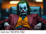 Portrait of a man in a bright clown costume with expressive makeup in the style of the Joker. The scene is filled with a tense atmosphere - the character sits in a chair, looking piercingly straight at the camera. Makeup, colors of the costume and lighting create a sense of drama and psychological depth. Ideal for use in projects related to the theme of cinema, theater, psychology, pop culture and images of antiheroes. Стоковое AI-изображение, AI-художник Анна Кривицкая / Фотобанк Лори