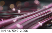 Close-up view of illuminated fiber optic cables showcasing vibrant colors in an abstract setting. Стоковое AI-видео, аниматор Сергей Толмачёв / Фотобанк Лори