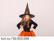 Happy funny child girl in witch costume on Halloween makes horror face and grimaces on white background. Halloween party girl. Happy Halloween Witch. High quality photo. Стоковое фото, фотограф Ирина Михайличенко / Фотобанк Лори