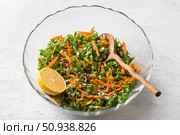 Salad with kale, carrots and seeds in a transparent salad bowl on a light gray background. Стоковое фото, фотограф Ольга Лепёшкина / Фотобанк Лори