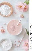 Spring smoothie composition on white marble, vibrant pink, drinkable wellness with flowers and ingredients displayed for a refreshing lifestyle. Стоковое AI-изображение, AI-художник Данила Большаков / Фотобанк Лори