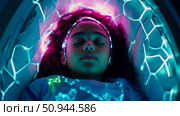 Concept: Futuristic Sleep; Young woman sleeping inside a cocoon of light for rest and recuperation. Стоковое AI-изображение, AI-художник Данила Большаков / Фотобанк Лори