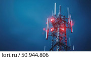 Modern telecommunications tower illuminated at night in urban setting. Стоковое AI-видео, аниматор Александр Довянский / Фотобанк Лори