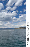 Baikal Lake on summer day. Vertical video of Small Sea Strait and shores of Olkhon Island from ferry board. Motorboat with tourists on blue water. Seagulls in sky with clouds. Стоковое видео, видеограф Виктория Катьянова / Фотобанк Лори