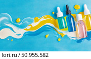 Colorful cosmetic oil serums and liquid paint on blue. Стоковое AI-изображение, AI-художник Данила Большаков / Фотобанк Лори