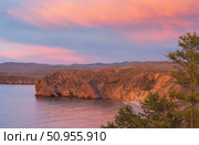 Beautiful bright sunset sky with pink clouds over shore of Baikal Lake after rain. View of Small Sea and the steppes of Olkhon Island. Scenic landscape. Natural background. Summer travel and recreation. Стоковое фото, фотограф Виктория Катьянова / Фотобанк Лори