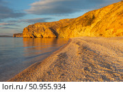Beautiful sunset landscape of Baika Lakel. View of pebble beach of Small Sea and rocky shores of Olkhon Island on quiet July evening. Picturesque landscape. Natural background. Summer travels. Стоковое фото, фотограф Виктория Катьянова / Фотобанк Лори