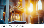 Regal gilded religious stand holding lit candles and a symbolic cross within a grand cathedral interior, bathed in ethereal golden rays, portraying solemn devotion. Стоковое AI-изображение, AI-художник Данила Большаков / Фотобанк Лори