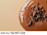 A sumptuous chocolate donut features a thick, glossy glaze in a top-down shot. This decadent pastry's rich sheen and indulgent allure make it an enticing dessert choice. Стоковое AI-изображение, AI-художник Nart / Фотобанк Лори