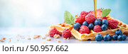 A delectable display of Belgian waffles drenched in luxurious maple syrup and adorned with fresh berries. The warm tones and vibrant colors create an irresistible and mouth-watering effect. Стоковое AI-изображение, AI-художник Nart / Фотобанк Лори