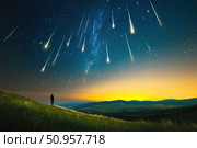 A vast field lies under a breathtaking night sky filled with shooting stars. The spectacle of meteors illuminates the midnight-blue heavens, creating a serene and mesmerizing natural phenomenon. Стоковое AI-изображение, AI-художник Nart / Фотобанк Лори