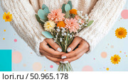 Warm hands in a cozy knitted sweater cradling a lovely bouquet of peach and white blooms against a soft blue backdrop, a tender gesture of appreciation, perfect for a greeting card or festive occasio. Стоковое AI-изображение, AI-художник Данила Большаков / Фотобанк Лори