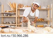 Adult male baker kneading dough on table. Стоковое фото, фотограф Яков Филимонов / Фотобанк Лори