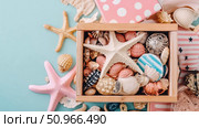 A serene flat lay composition featuring a wooden box brimming with various seashells and starfish, embodying a relaxed beach summer vacation concept, suitable for home decor, print, and greeting card. Стоковое AI-изображение, AI-художник Данила Большаков / Фотобанк Лори