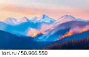 Panoramic Mountain Forest Fire with Intense Flames and Billowing Smoke Below Snow-Capped Peaks at Dawn, Illustrating Environmental Impact and Natural Disaster. Стоковое AI-изображение, AI-художник Данила Большаков / Фотобанк Лори