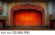 A vintage proscenium arch theatre stage featuring worn red velvet curtains and aged golden ornamentation for a classic performing arts event. Стоковое AI-изображение, AI-художник Данила Большаков / Фотобанк Лори