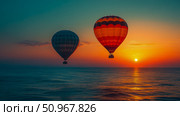 Two vibrant hot air balloons ascend gracefully above the calm ocean during a magnificent, colorful sunset, inspiring tranquility and adventure. Стоковое AI-изображение, AI-художник Данила Большаков / Фотобанк Лори