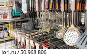 A rack of kitchen utensils including spatulas, whisks, and ladles. Russia. Moscow. 02.08.25. Редакционное фото, фотограф Ярославский Максим / Фотобанк Лори
