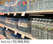 A row of water bottles on a shelf. Russia. Moscow. 02.08.25. Редакционное фото, фотограф Ярославский Максим / Фотобанк Лори