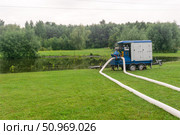 Landscape of a flooded park after heavy rains, a pump drains water. Стоковое фото, фотограф Евгений Харитонов / Фотобанк Лори