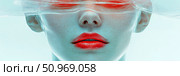 Striking close-up portrait featuring a person's lower face with vibrant red lips, obscured above by a transparent, rippled veil, bathed in cool cyan tones with a warm red accent. Стоковое AI-изображение, AI-художник Данила Большаков / Фотобанк Лори