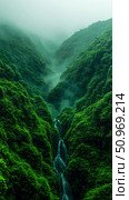 Deep emerald green canyon veiled in ethereal mist, showcasing a pristine multi-tiered waterfall nestled within a vibrant, untouched natural landscape. Стоковое AI-изображение, AI-художник Данила Большаков / Фотобанк Лори