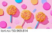 Playful trio of golden-fried-textured lollipops adorned with vibrant pink squiggles, artfully arranged amidst a confetti of abstract shapes on a bright pink background. Стоковое AI-изображение, AI-художник Данила Большаков / Фотобанк Лори