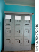 Electrical cabinet showing fuses and switches in room with turquoise wall. Стоковое фото, фотограф Андрей Знаменский / Фотобанк Лори