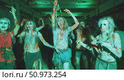 A haunting assembly of undead performers with gruesome makeup and tattered attire, illuminated by an eerie green glow in a dark, confined space. Стоковое AI-видео, аниматор Данила Большаков / Фотобанк Лори
