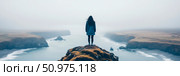 Solitude on a Misty Coastline: A Woman Contemplates the Ocean from a Clifftop. Стоковое AI-изображение, AI-художник Данила Большаков / Фотобанк Лори