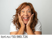 Mature woman shows surprise on her face, eyes wide open and mouth slightly agape, revealing shock or unexpected news. Стоковое AI-изображение, AI-художник Данила Большаков / Фотобанк Лори