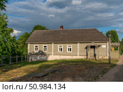 Izborsk, Pechersk district, Pskov region, Russia, June 10, 2024: View of the historical merchant building of the estate on the main street of Izborsk- Pecherskaya - on a sunny summer day. Редакционное фото, фотограф Ula Ulachka / Фотобанк Лори