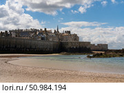 View of the fortress city of Saint-Malo on the English Channel and the ocean floor exposed at low tide on a sunny summer day, Brittany, France. Стоковое фото, фотограф Ula Ulachka / Фотобанк Лори
