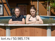 Two teenage sisters swimming in the pool. Стоковое фото, фотограф Андрей Аркуша / Фотобанк Лори