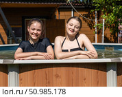 Two teenage sisters swimming in the pool. Стоковое фото, фотограф Андрей Аркуша / Фотобанк Лори